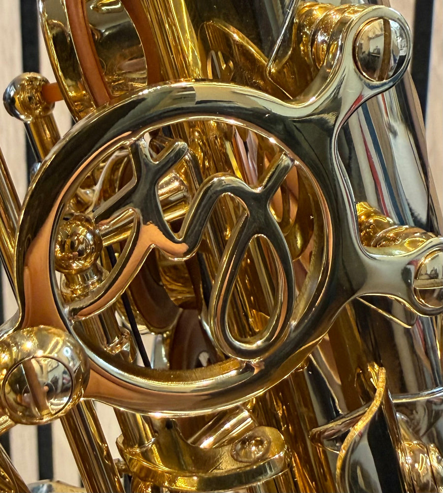 Trevor James SR alto saxophone in gold lacquer – close-up of the decorative bell brace and engraved detail
