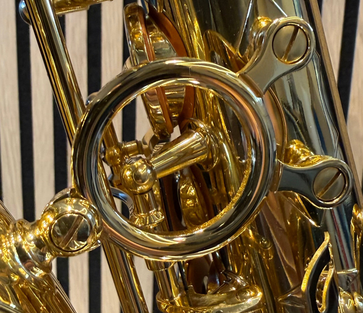 Trevor James The Horn alto saxophone in gold lacquer – close-up of decorative bell brace and mounting hardware
