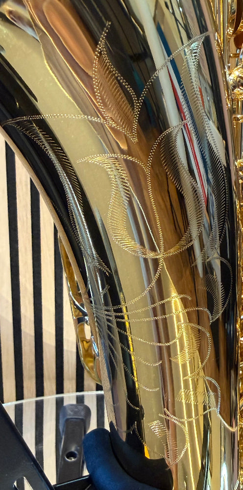 Trevor James The Horn tenor saxophone in gold lacquer – close-up of detailed floral bell engraving
